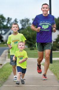 Jeremy Sanders runs in his Frederick County neighborhood with his sons, Connor, 8, and Cole, 2. Sanders started the For Lucas 10X10 Challenge in memory of his late son Lucas. Sanders and his wife, Jennifer, set up the fund to provide other neonatal intensive care unit babies with diapers, pacifiers, blankets, and even hotel stays for parents.