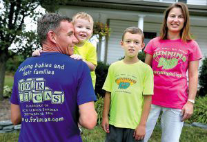 The Sanders family are dad Jeremy (from left), Cole, 2, Connor, 8, and mom, Jennifer. Jeremy, 38, is challenging other runners to take part in the For Lucas 10x10 Challenge — run 10 miles a day for 10 days straight, and do it all before the end of September. The runners gather sponsors and any money raised goes to the neonatal intensive care unit at University of Virginia Children's Hospital.